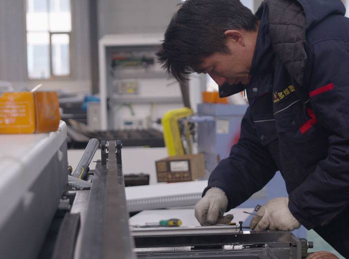Dowell Laser technician assembling and checking machine components